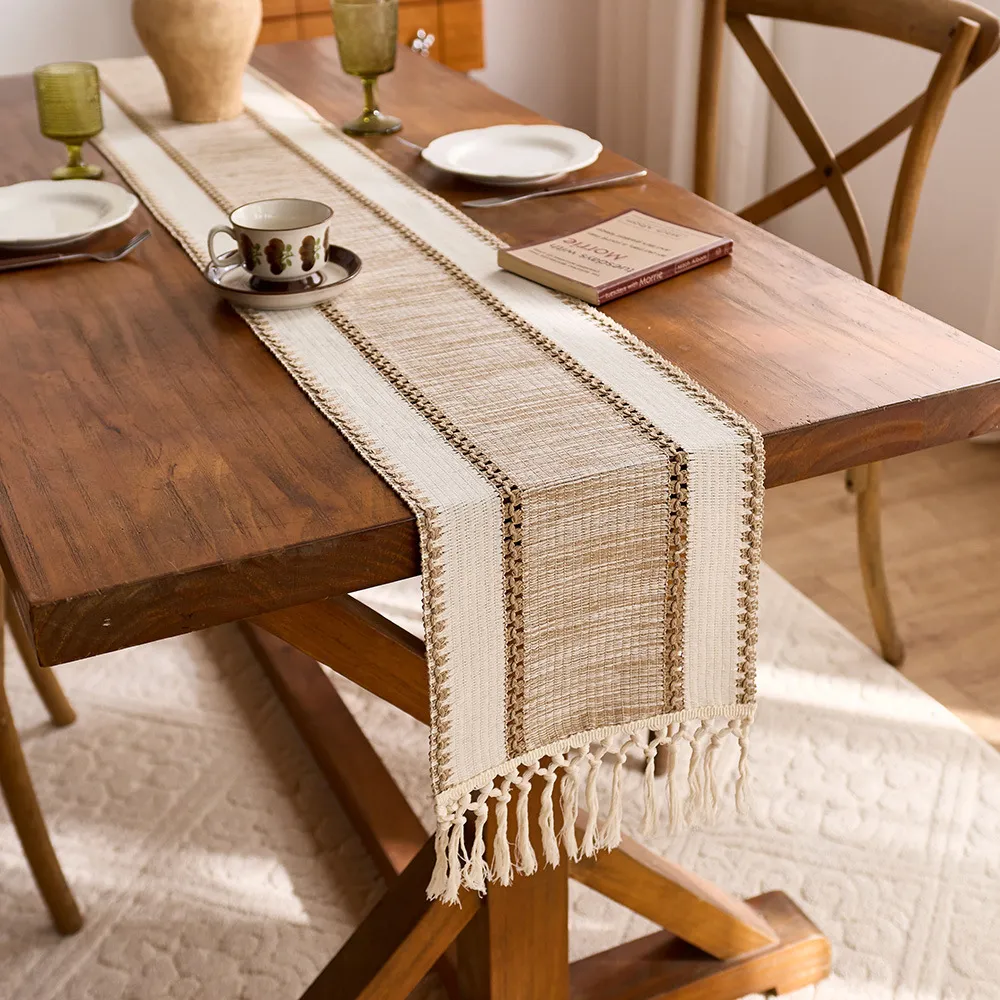 Brown stripe table runner draped lengthwise across a wooden dining table