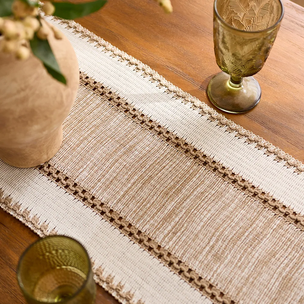 Runner used beneath a vase and beside a glass; accessories not included