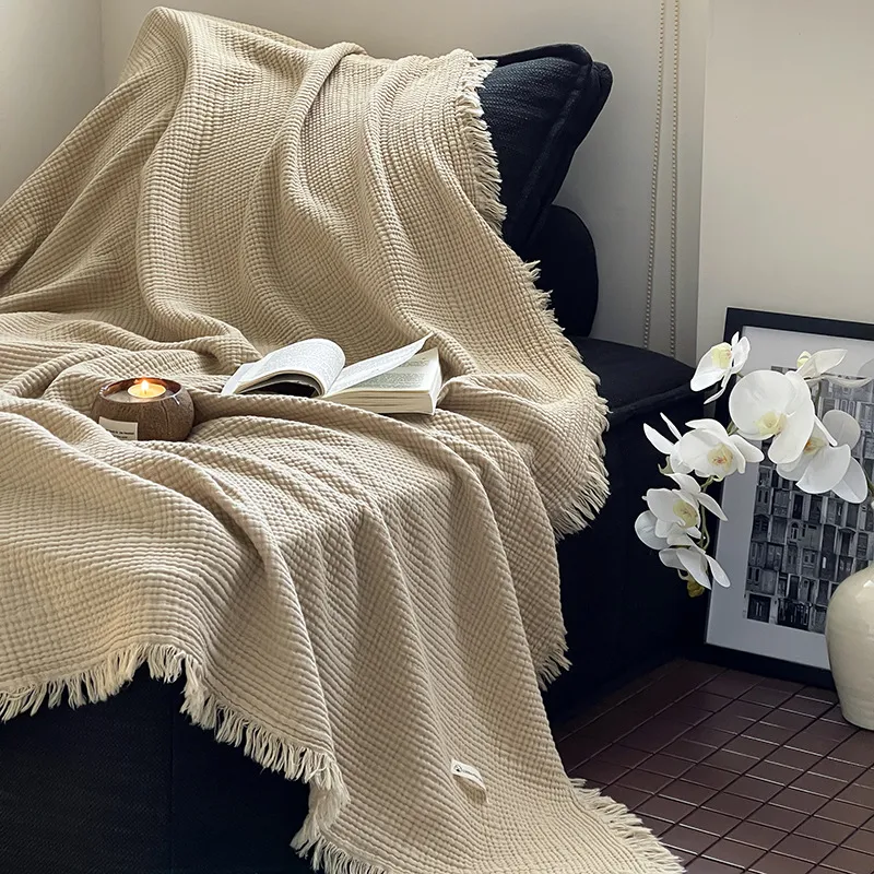 Cream cotton gauze throw draped over a chair; accessories not included